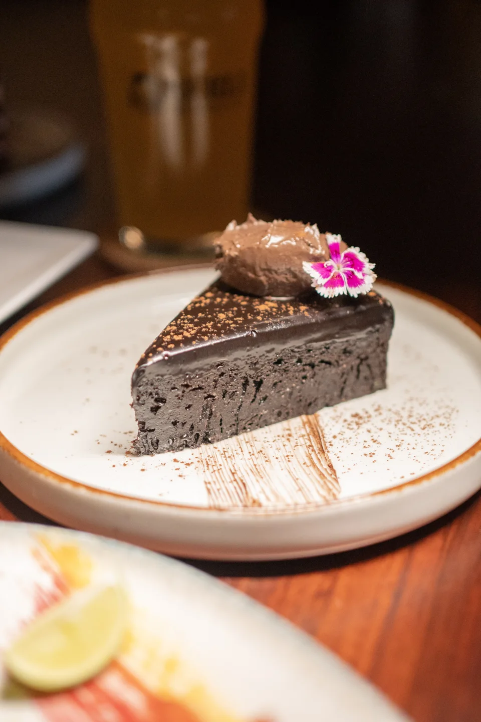 A slice of chocolate cake on a white plate